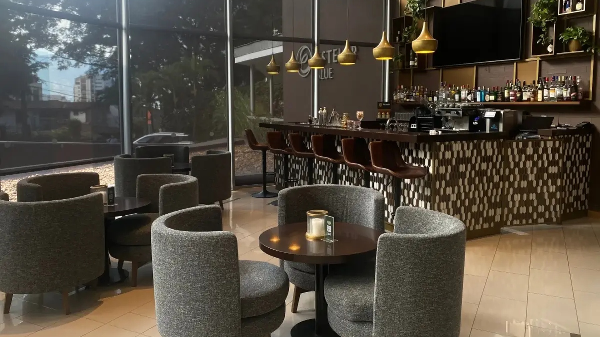 the bar and lounge area of the Fiola Trattoria restaurant located inside the Hotel Estelar Blue in Medellín, Colombia