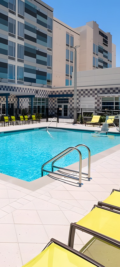 the outdoor swimming pool area at the SpringHill Suites by Marriott Lakeland hotel in Lakeland, Florida