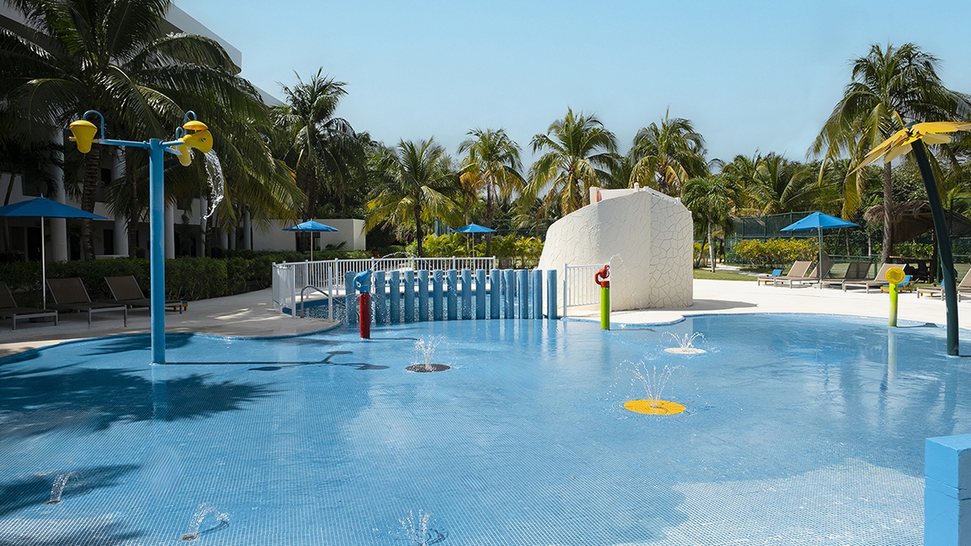 a swimming pool area at the Iberostar Selection Riviera Cancún resort, located near Puerto Morelos, Mexico