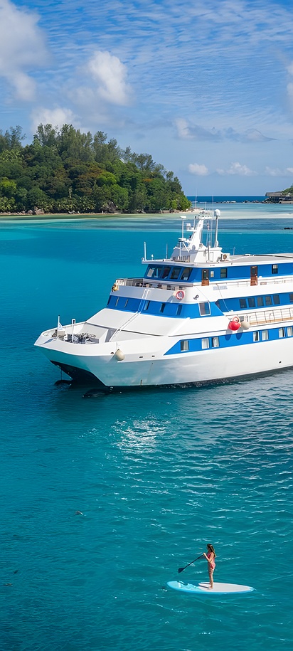the M/Y Pegasos, a 45-meter mega yacht operated by Variety Cruises, anchored off the coast of an island in the Seychelles