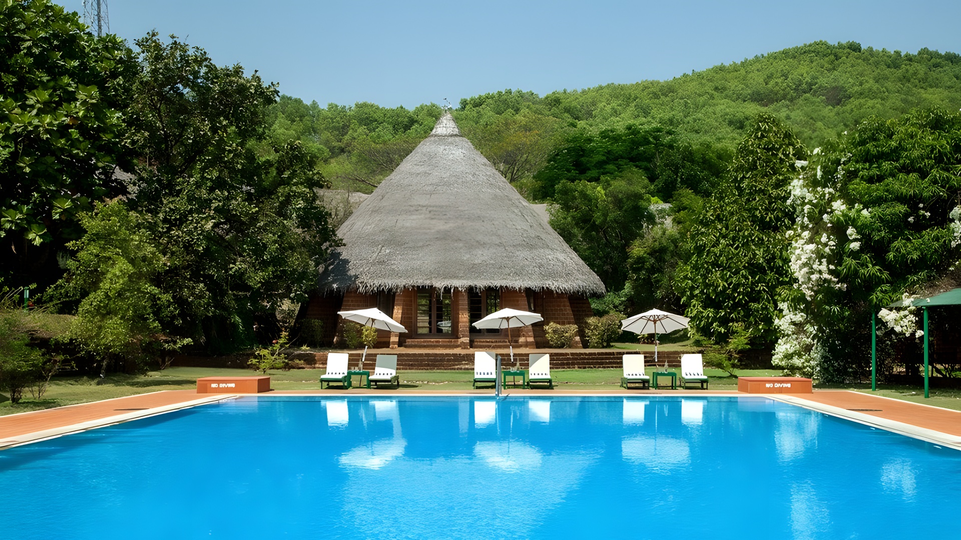 the swimming pool and main building at SwaSwara Wellness Retreat, a hotel managed by CGH Earth located on Om Beach in Gokarna, Karnataka, India