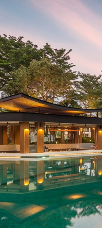 a tranquil evening view of the main swimming pool at the Dusit Thani Krabi Beach Resort in Thailand