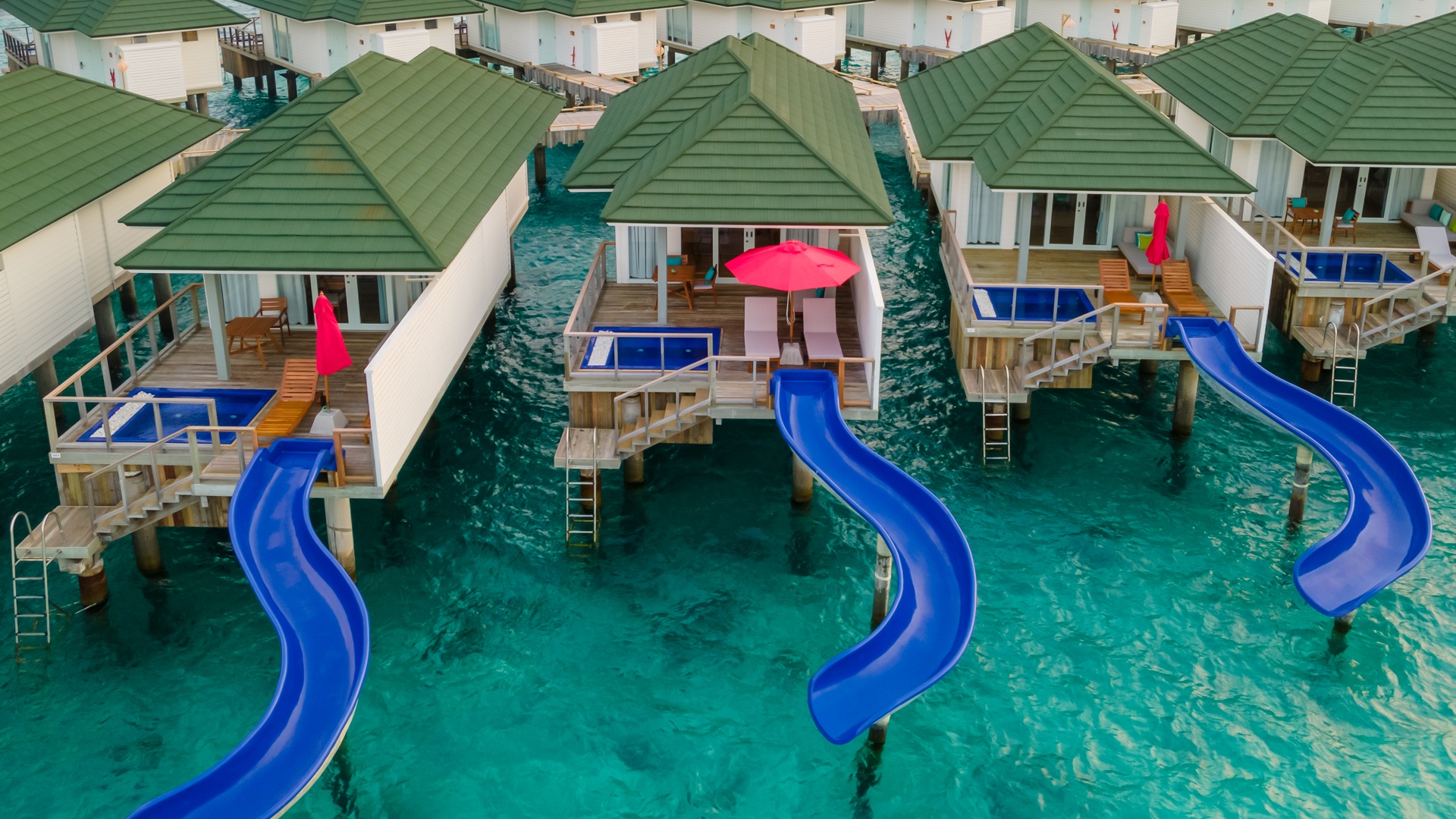 Overwater villas with slides at Siyam World Maldives