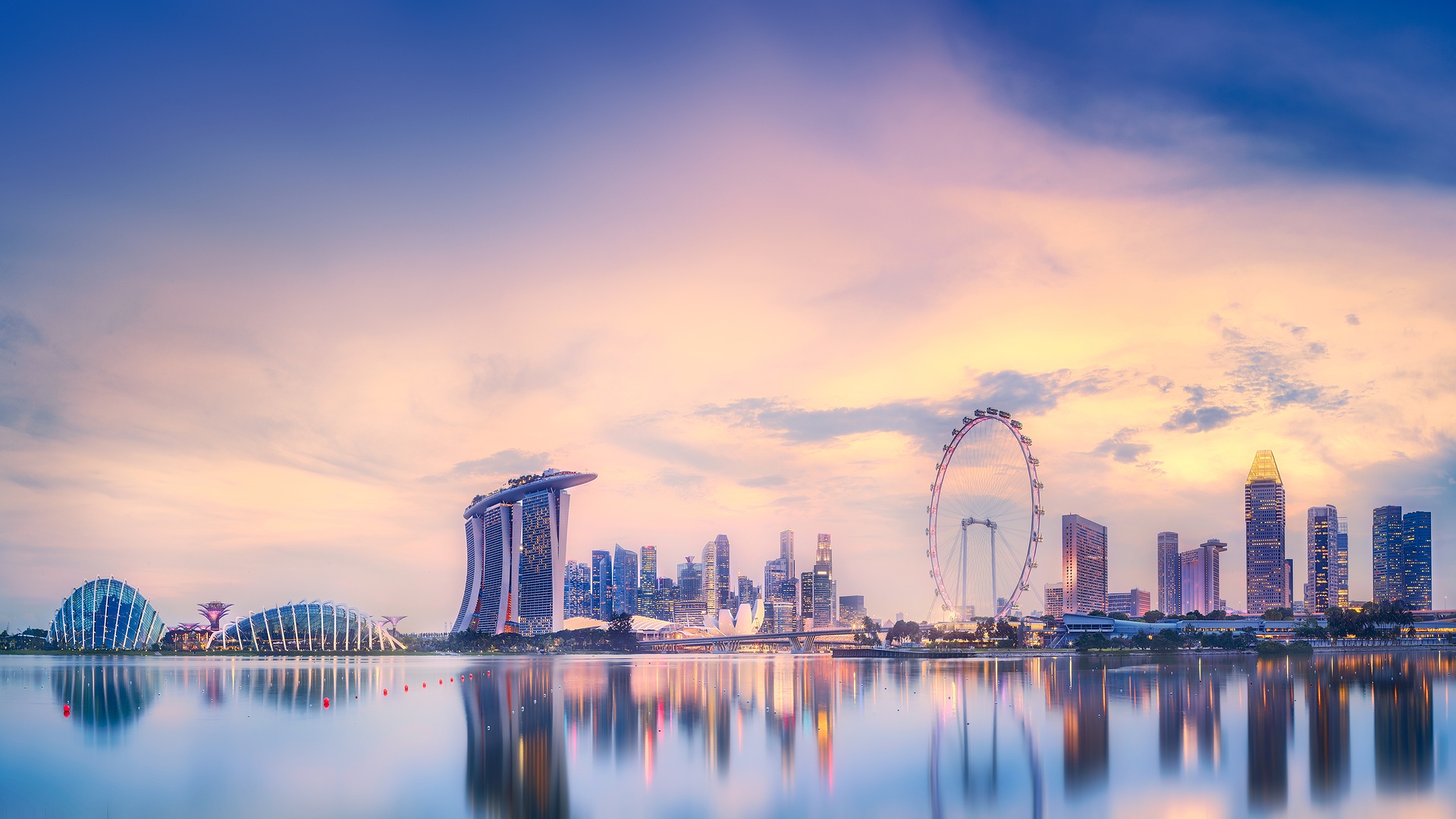  scenic view of the Singapore skyline featuring the Marina Bay Sands resort and the Singapore Flyer Ferris wheel