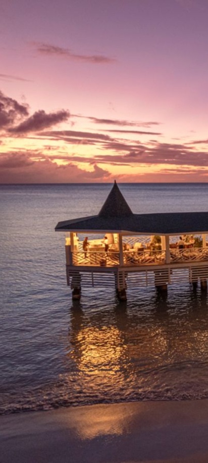 sunset view of the Pescari Overwater Restaurant at the Royalton CHIC Antigua resort