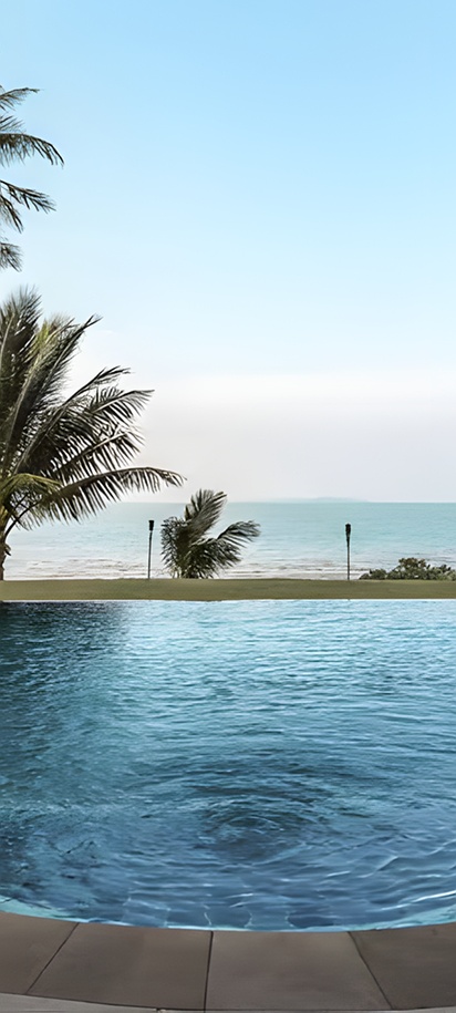 a luxury tropical resort pool overlooking the ocean at the Barceló Coconut Island resort in Phuket, Thailand