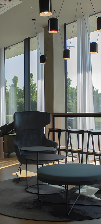 the lobby and lounge area of the Park Inn by Radisson Vilnius Airport Hotel & Business Centre