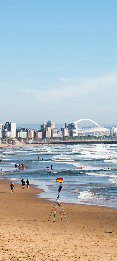 view of the Durban coastline, specifically highlighting the Golden Mile beachfront and the city skyline in South Africa