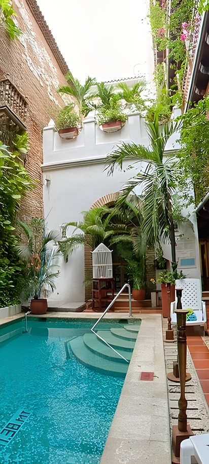 the central courtyard and swimming pool of the Hotel Don Pedro de Heredia, located in the historical center of Cartagena, Colombia