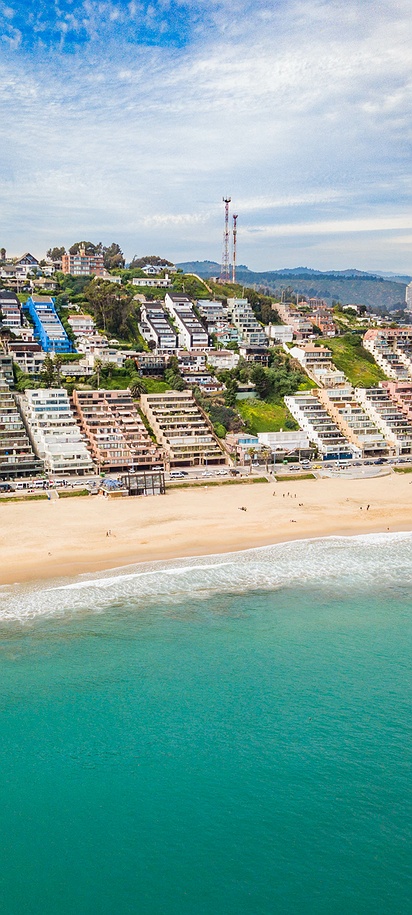 Coastal city view with beach and hillside buildings in Chile