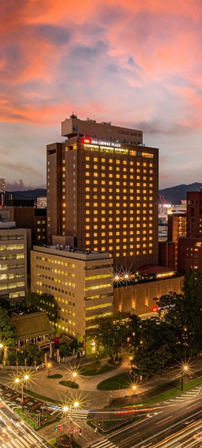 a scenic view of the ANA Crowne Plaza Hiroshima hotel and the surrounding skyline during sunset