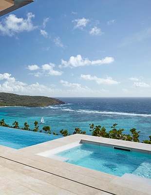 a scenic view of the Mandarin Oriental, Canouan resort located on the island of Canouan in St. Vincent and the Grenadines