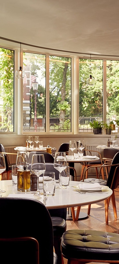 the interior dining area of the TOZI Restaurant & Bar located inside the Park Plaza Vondelpark hotel in Amsterdam