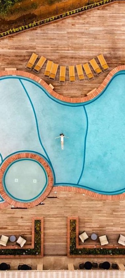 an aerial view of the outdoor pool area at the Radisson Safari Hotel Hoedspruit in South Africa
