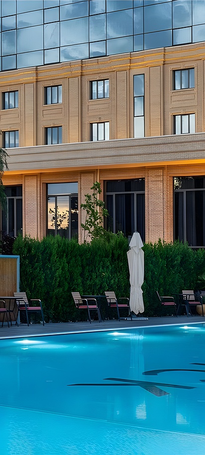 the outdoor swimming pool area at the Mövenpick Samarkand hotel in Samarkand, Uzbekistan