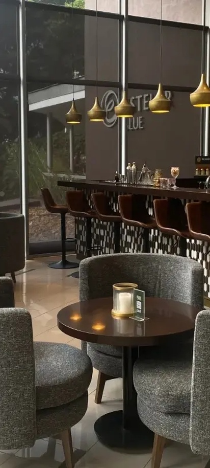the bar and lounge area of the Fiola Trattoria restaurant located inside the Hotel Estelar Blue in Medellín, Colombia