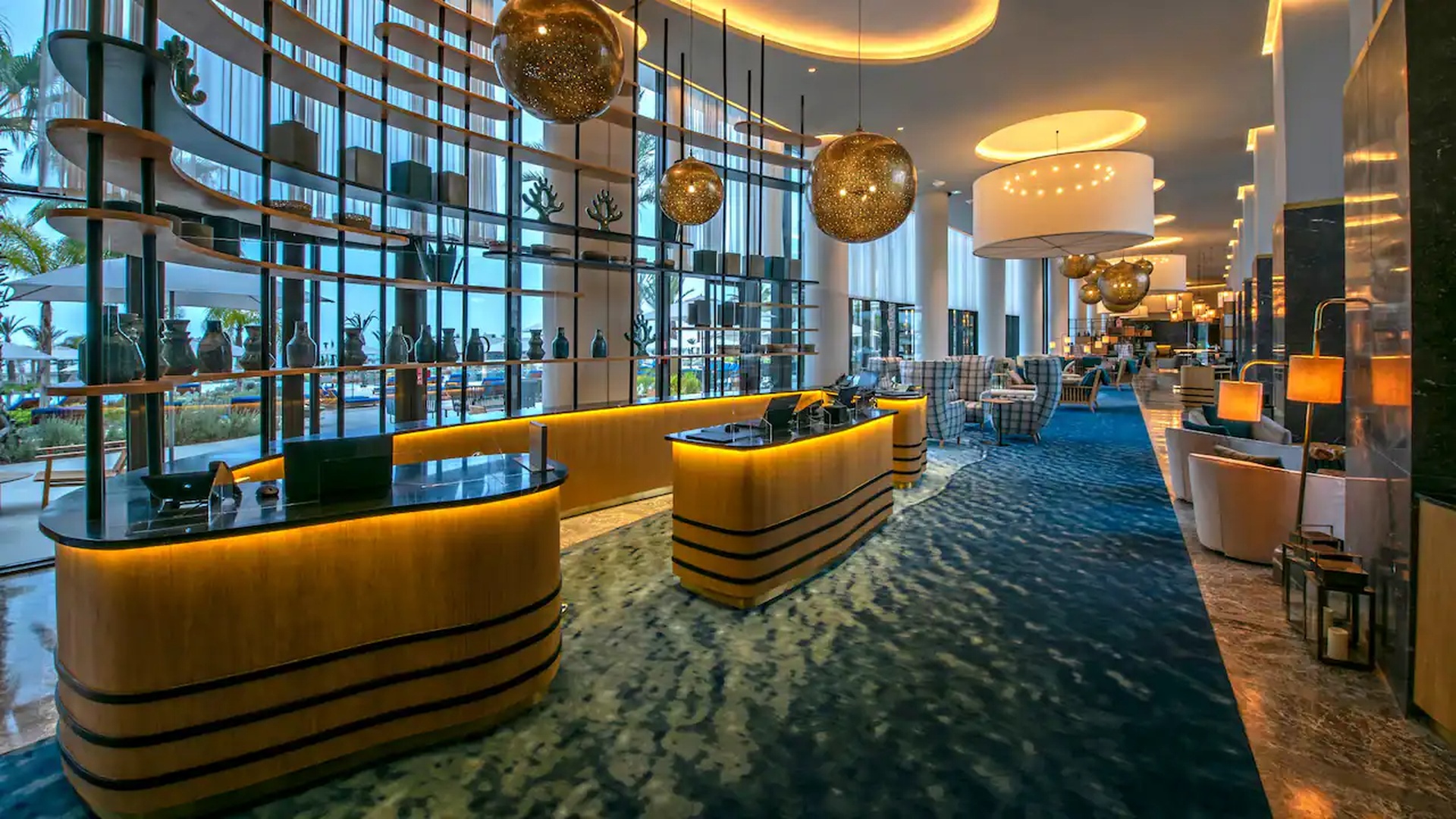 the modern lobby and reception area of the Hyatt Regency Taghazout hotel located in Agadir, Morocco