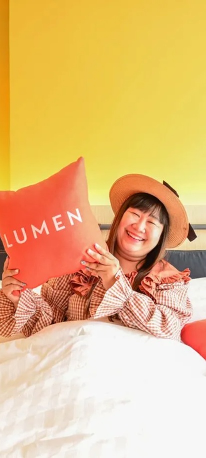 a cozy room at the Lumen Bangkok Udomsuk Station hotel in Thailand.
