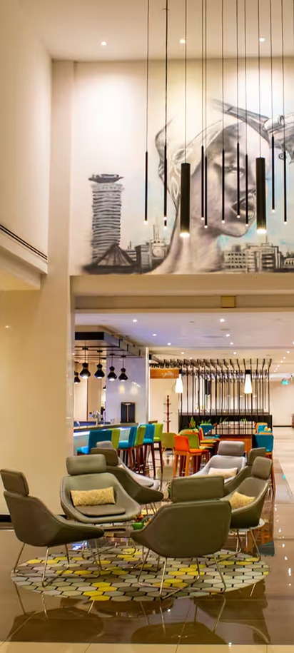 the lobby and lounge area of the Hilton Garden Inn Nairobi Airport in Kenya