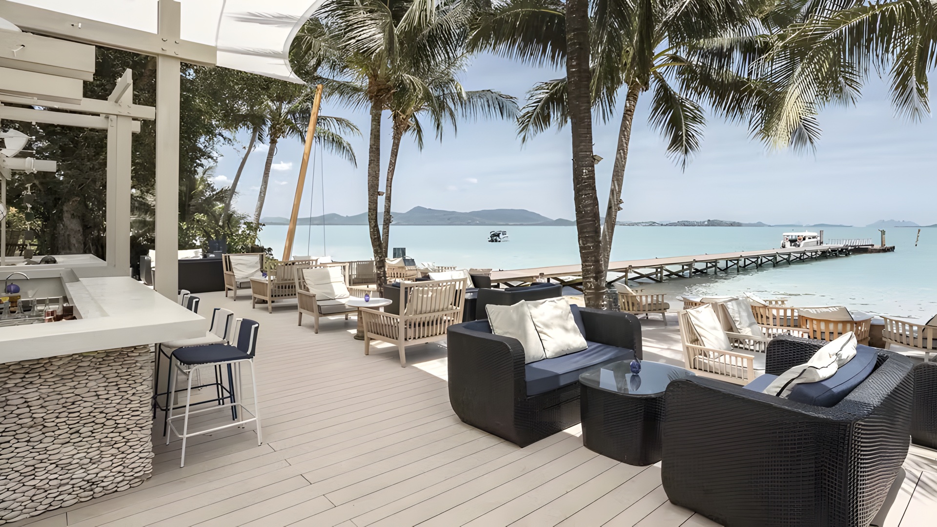 the beachfront bar and seating area at the Barceló Coconut Island resort in Phuket, Thailand