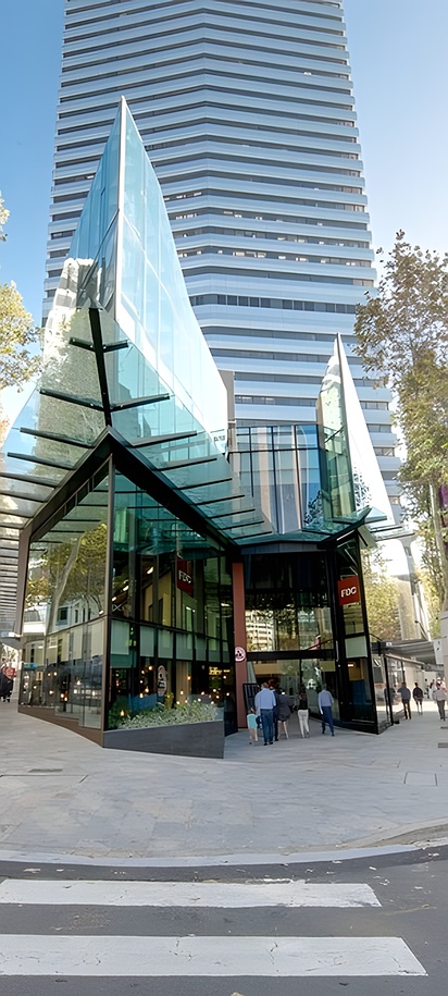 the exterior of the Vibe Hotel North Sydney located on the Pacific Highway