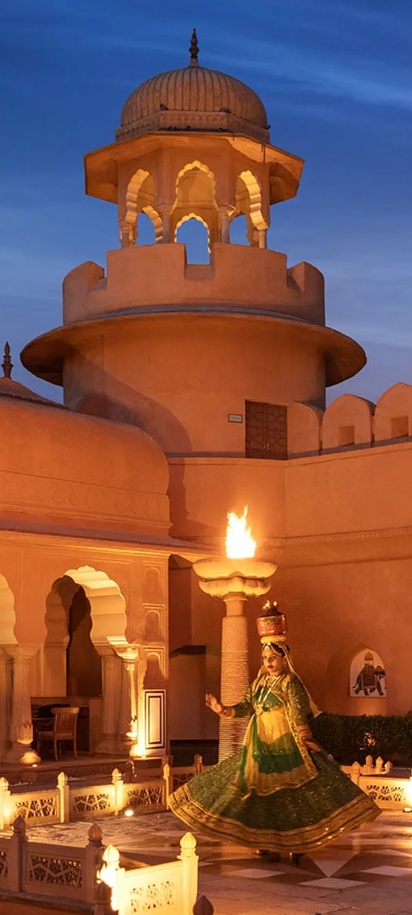 an evening cultural performance with a traditional folk dancer in the courtyard of The Oberoi Rajvilas