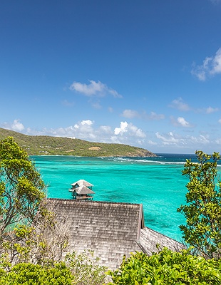 a scenic view of the Mandarin Oriental, Canouan resort located on the island of Canouan in St. Vincent and the Grenadines